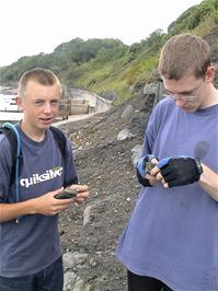 Ashley and Oliver look for fossils at Lyme Regis Beach
