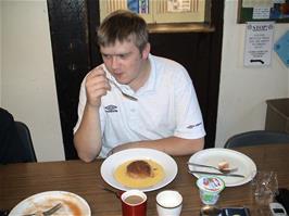 Gavin enjoy's the warden's treacle pudding at Bellever Youth Hostel