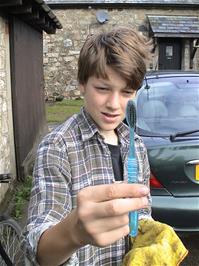 Gage shows us the toothbrush he uses for cleaning his bike, at Bellever Youth Hostel