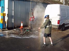 Keir and Joe take drastic measures to clean their bikes at Dial Motors, Buckfastleigh