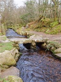 The stone clapper bridge at the bottom of the valley, over the Becka Brook