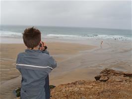 Ash takes video shots of Perranporth Beach from the top of Chapel Rock