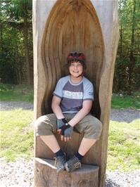 Zac explores the carved chair on the Play Trail