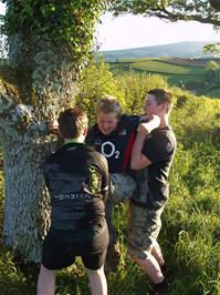 Ash and Zac help new member Matt up into the tree