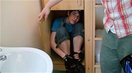 Zac demonstrates that he can almost fit in one of the storage cupboards in our room at Bath Youth Hostel