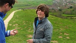 Ash gives his wallet and other valuables to Tao before rolling down Glastonbury Tor