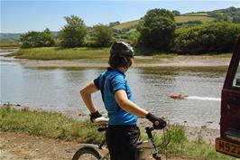 Ash watches a remote-controlled speedboat heading up the Avon estuary