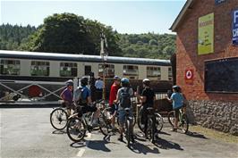 A steam train passes through Staverton Station