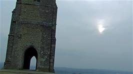 Moody skies, a watery sun and chilly conditions on Glastonbury Tor