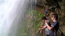 Ash takes photos of the Giessbach Falls from underneath the waterfall