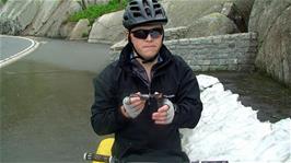 Ash prepares to carve the snow lying by the road above Lake Grimsel, 27.2 miles, 1947m