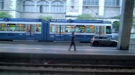 Trams pass Zurich rail station on a very wet morning