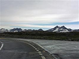 Snowy mountains all around as we reach the flat road on top of Grimsel Pass