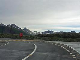 Snowy mountains all around as we reach the flat road on top of Grimsel Pass