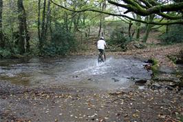 Lawrence washes off the mud at the ford near Cross Furzes