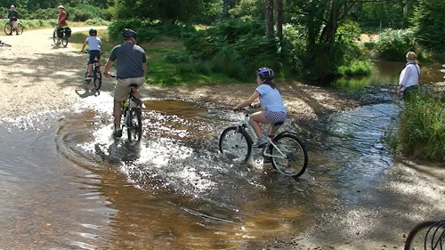 A family of cyclists cross the ford with no difficulty