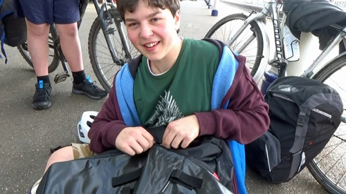 Lawrence tries to repair his pannier zip at Taunton station.