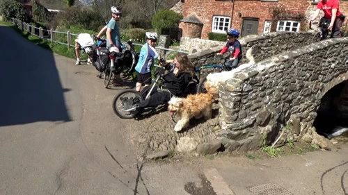 Unusual recumbent trike with Rann trailer crosses Allerford bridge.