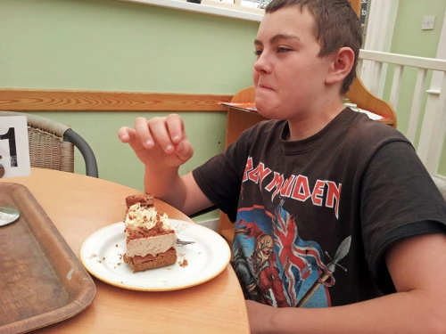 Dillan savours his chocolate flake cheesecake at Fermoy's Garden Centre. New photo for 2024.