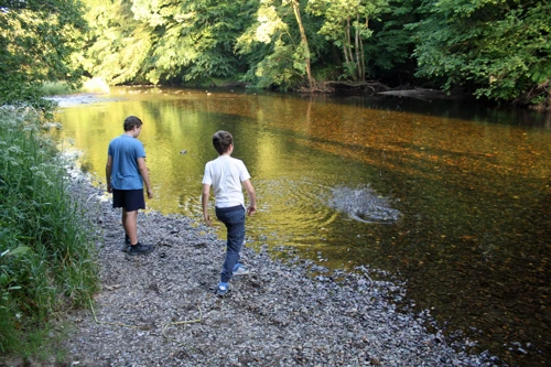Skimming stones on the River Dart.