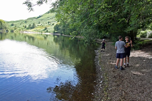 Stone-skimming on the banks of Grasmere.