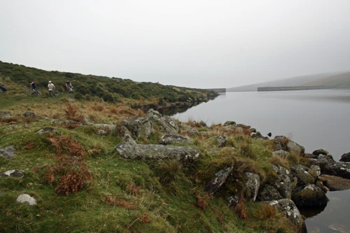 Negotiating the rough track beside the reservoir.