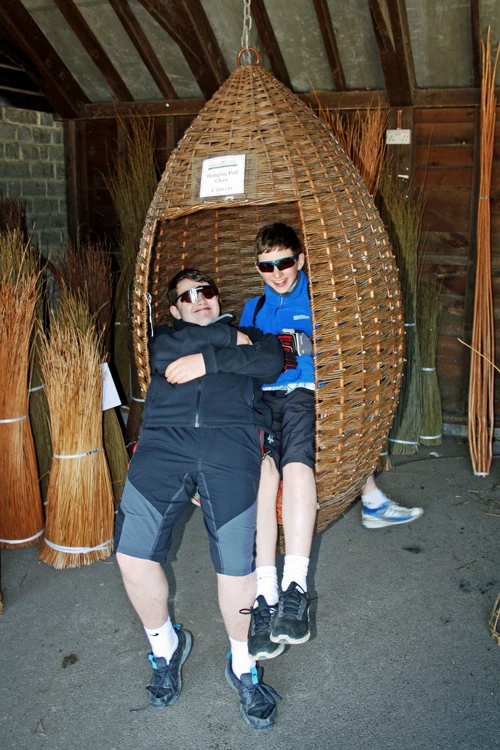 Dillan and George share the wicker Hanging Pod Chair at the Willows & Wetlands Centre.