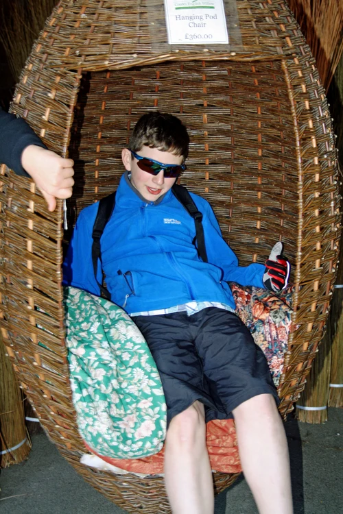 George tries a wicker Hanging Pod Chair at the Willows & Wetlands Centre.