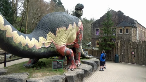 Dillan and George with the brachiosaurus in Dinosaur Grove, Wookey Hole.