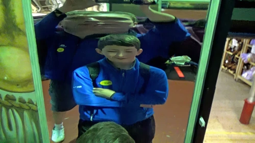 George puts on weight in the Hall of Mirrors, Wookey Hole.