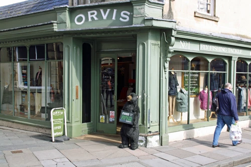 A bear lends a paw outside a shop near Pulteney Bridge, Bath