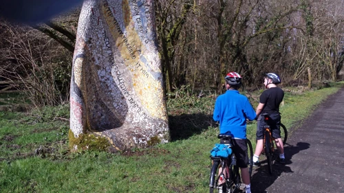 George and Dillan admire the Tarka Trail mosaic featuring Tarka the Otter quotes, 4.7 miles in.