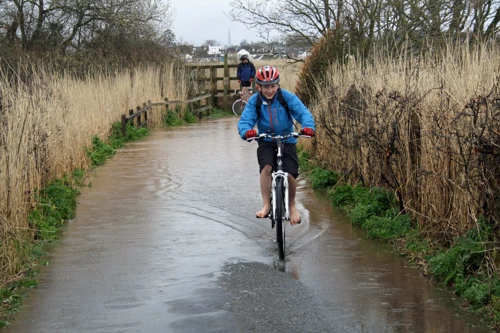 Barefoot George emerges from the flood.
