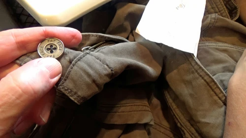 Button secured: Lawrence finishes repairs to his cycling shorts.