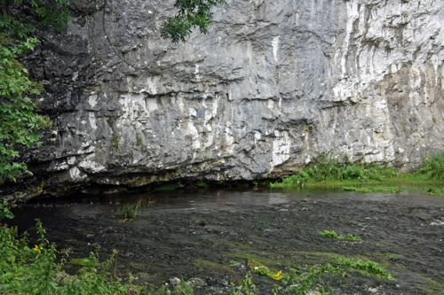 Malham Beck emerging from the cave system behind Malham Cove.
