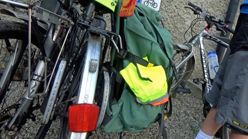 Another hosteller straps a rucksack to his bike with squash rackets.