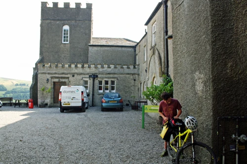 Lawrence in the courtyard at Grinton Lodge Youth Hostel.