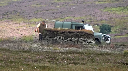 Landowner strims a grouse hide (butt) before the descent to Egton Bridge, 21.5 miles in.