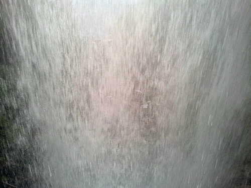 A view of Giessbach Falls from underneath the waterfall