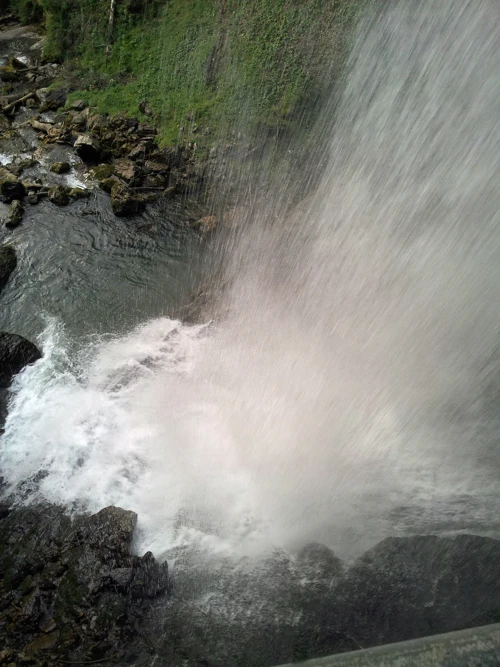 A view of Giessbach Falls from underneath the waterfall